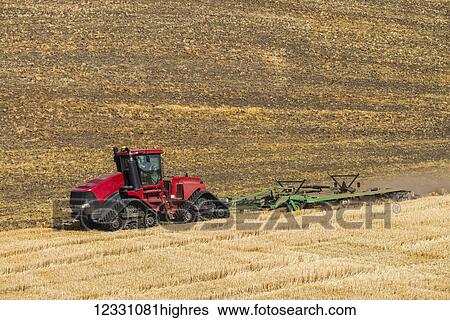 Stock Photograph - Quadtrac Tractor Discing A Field Of Wheat Stubble In The Palouse Region Of Eastern Washington; Washington, United States Of Ameica. Fotosearch