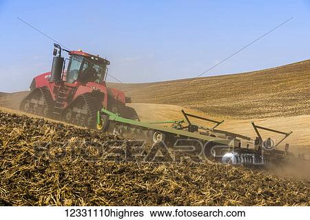 Stock Photograph - Quadtrac Tractor Discing A Field Of Wheat Stubble In The Palouse Region Of Eastern Washington; Washington, United States Of America. Fotosearch