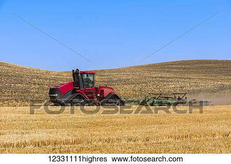 Stock Photograph - Quadtrac Tractor Discing A Field Of Wheat Stubble In The Palouse Region Of Eastern Washington; Washington, United States Of America. Fotosearch