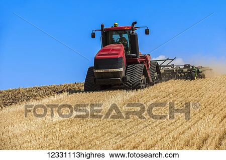 Stock Photograph - Quadtrac Tractor Discing A Field Of Wheat Stubble In The Palouse Region Of Eastern Washington; Washington, United States Of America. Fotosearch