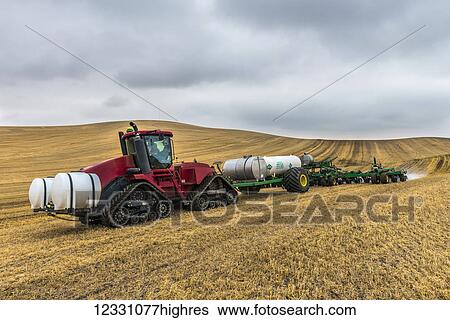 Quadtrac Tractor Pulling An Anhydrous Ammonia Tank And Applicator Applying The Anhydrous To A Field In Advance Of Preparing It For Planting In The Palouse Region Of Eastern Washington; Washington, United States Of America View Large Photo Image Stock Photograph - Quadtrac Tractor Pulling An Anhydrous Ammonia Tank And Applicator Applying The Anhydrous To A Field In Advance Of Preparing It For Planting In The Palouse Region Of Eastern Washington; Washington, United States Of America. Fotosearch