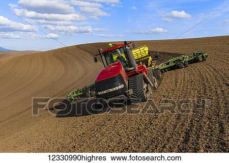 Stock Photograph - Quadtrac Tractor Seeding Garbanzo Beans In The Palouse Region Of Eastern Washington; Washington, United States Of America. Fotosearch