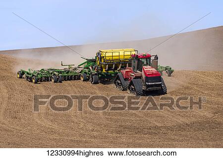 Stock Photograph - Quadtrac Tractor Seeding Garbanzo Beans In The Palouse Region Of Eastern Washington; Washington, United States Of America. Fotosearch