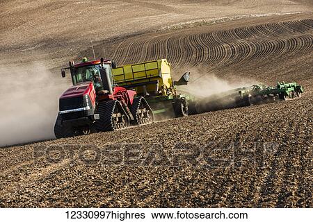 Stock Photograph - Quadtrac Tractor Seeding Garbanzo Beans In The Palouse Region Of Eastern Washington; Washington, United States Of America. Fotosearch