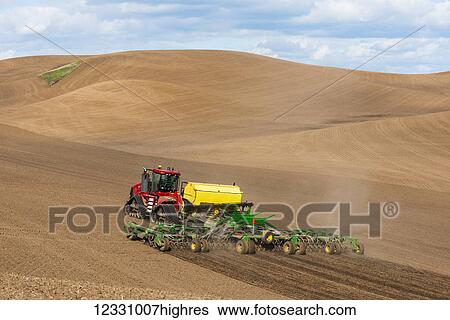Stock Photograph - Quadtrac Tractor Seeding Garbanzo Beans In The Palouse Region Of Eastern Washington; Washington, United States Of America. Fotosearch