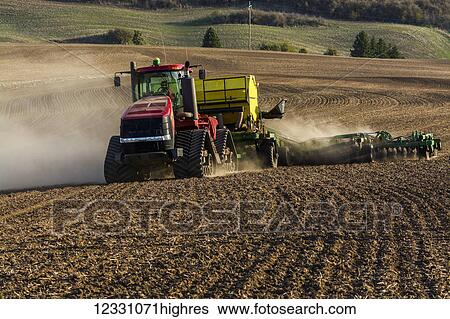 Stock Photograph - Quadtrac Tractor Seeding Garbanzo Beans In The Palouse Region Of Eastern Washington; Washington, United States Of America. Fotosearch