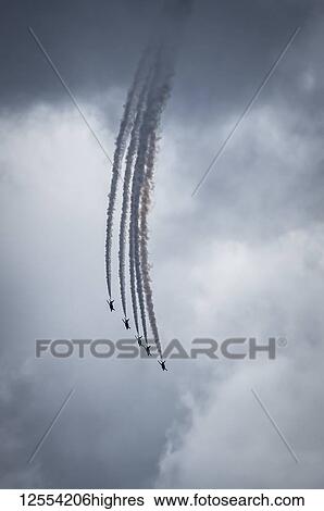 Red Arrows air display, five planes descending in flying formation against grey clouds; South Shields, Tyne and Wear, England View Large Photo Image Stock Photograph - Red Arrows air display, five planes descending in flying formation against grey clouds; South Shields, Tyne and Wear, England. Fotosearch
