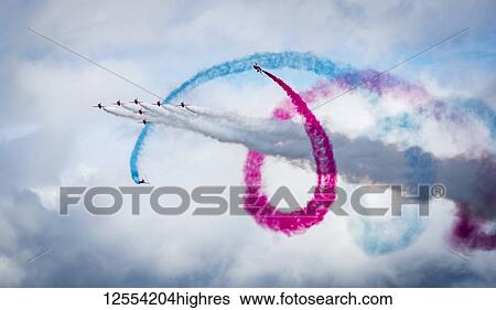 Red Arrows air display, nine planes flying in formation with colourful contrails; South Shields, Tyne and Wear, England View Large Photo Image Stock Photograph - Red Arrows air display, nine planes flying in formation with colourful contrails; South Shields, Tyne and Wear, England. Fotosearch