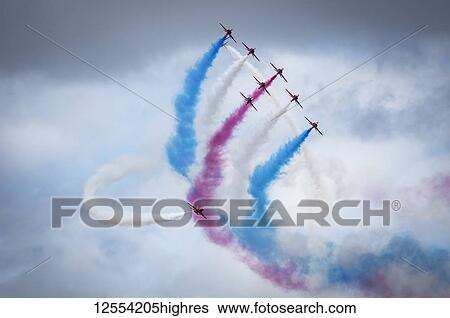 Red Arrows air display, nine planes flying in formation with colourful contrails; South Shields, Tyne and Wear, England View Large Photo Image Stock Photograph - Red Arrows air display, nine planes flying in formation with colourful contrails; South Shields, Tyne and Wear, England. Fotosearch