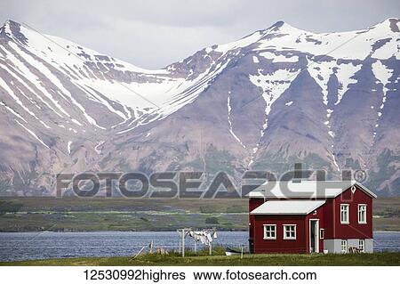 Stock Photograph - Red house along the shoreline in Northern Iceland; Iceland. Fotosearch