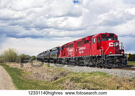 Red Train Engine With Rail Oil Tanks; Alberta, Canada View Large Photo Image Stock Photograph - Red Train Engine With Rail Oil Tanks; Alberta, Canada. Fotosearch