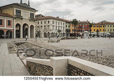 Stock Photograph - Renaissance architecture and city life in a town square; Palmanova, Italy. Fotosearch