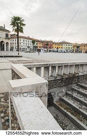 Stock Photograph - Renaissance architecture and city life in a town square; Palmanova, Italy. Fotosearch