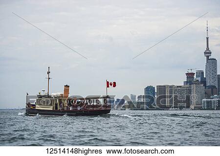 Royal Canadian Yacht Club (RCYC) launch heading to the Toronto island at dawn; Toronto, Ontario, Canada View Large Photo Image Stock Photograph - Royal Canadian Yacht Club (RCYC) launch heading to the Toronto island at dawn; Toronto, Ontario, Canada. Fotosearch