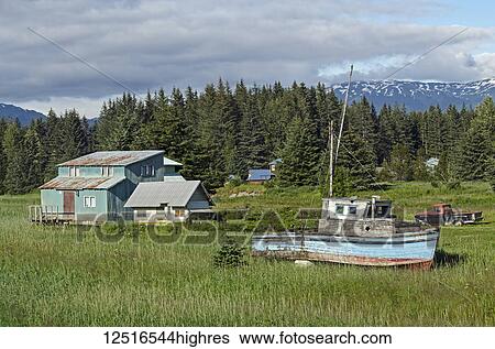 Rustic wooden boat and home on the grass shore near ferry dock, Southeast Alaska; Gustavus, Alaska, United States of America View Large Photo Image Stock Photograph - Rustic wooden boat and home on the grass shore near ferry dock, Southeast Alaska; Gustavus, Alaska, United States of America. Fotosearch