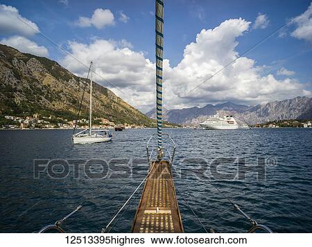 Stock Photograph - Sailboats and a cruise ship outside Kotor in the Bay of Kotor; Kotor, Kotor Municipality, Monte. Fotosearch