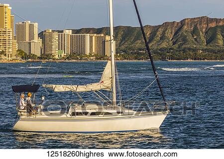 Stock Photograph - Sailing from the Ala Wai boat harbor past Waikiki and Diamond Head; Honolulu, Oahu, Hawaii, United States of America. Fotosearch