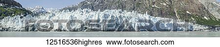 Stock Photograph - Scenic view of Margerie Glacier moraine and the Fairweather Range in the St. Elias Mountains, Tarr Inlet, Glacier Bay National Park and Preserve, Southeast Alaska; Alaska, United States of America. Fotosearch