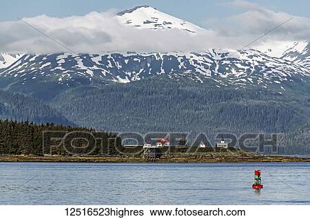 Scenic view of Point Retreat Lighthouse with Chilkat Mountains in the background, Southeast Alaska; Juneau, Alaska, United States of America View Large Photo Image Stock Photograph - Scenic view of Point Retreat Lighthouse with Chilkat Mountains in the background, Southeast Alaska; Juneau, Alaska, United States of America. Fotosearch