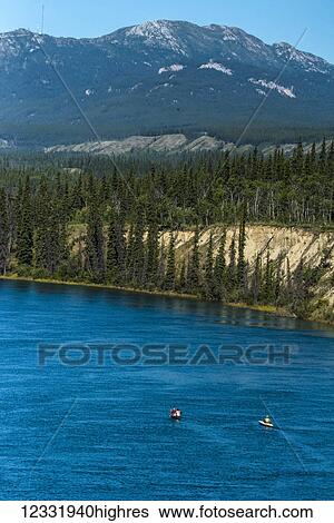 Stock Photograph - Scenic view of the Yukon River south of Whitehorse and Grey Mountain in the background; Yukon Territory, Canada. Fotosearch