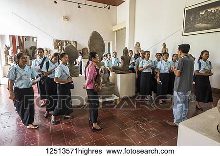 Stock Photograph - School girls in the Gallery of Khmer Art at the National Museum of Arts; Phnom Penh, Cambodia. Fotosearch