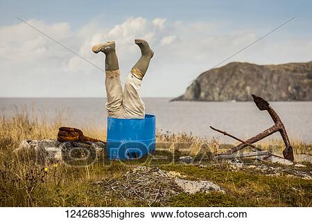 Sculpture of man's legs wearing rubber boots upside down in a barrel along the Atlantic coast; Newfoundland, Canada View Large Photo Image Stock Photograph - Sculpture of man's legs wearing rubber boots upside down in a barrel along the Atlantic coast; Newfoundland, Canada. Fotosearch