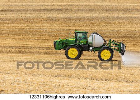 Stock Photograph - Self-Propelled Sprayer Spraying Herbicide On A Field In Advance Of Preparing It To Plant In The Palouse Region Of Eastern Washington; Washington, United States Of America. Fotosearch