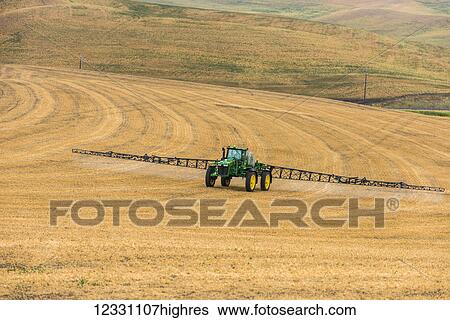 Stock Photograph - Self-Propelled Sprayer Spraying Herbicide On A Field In Advance Of Preparing It To Plant In The Palouse Region Of Eastern Washington; Washington, United States Of America. Fotosearch