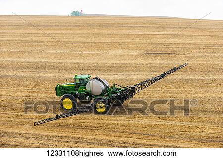 Stock Photograph - Self-Propelled Sprayer Spraying Herbicide On A Field In Advance Of Preparing It To Plant In The Palouse Region Of Eastern Washington; Washington, United States Of America. Fotosearch