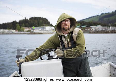 Set-netter driving his skiff, Seldovia Bay, South-central Alaska; Alaska, United States of America View Large Photo Image Stock Photograph - Set-netter driving his skiff, Seldovia Bay, South-central Alaska; Alaska, United States of America. Fotosearch