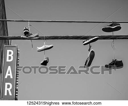 Stock Photograph - Shoes dangling from the wires above the Venice Beach Boardwalk; Los Angeles, California, United States of America. Fotosearch
