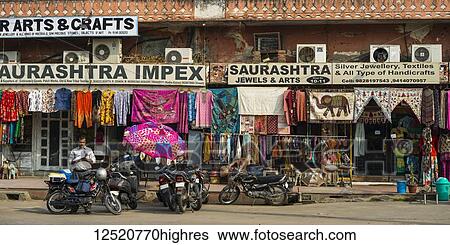 Stock Photograph - Shops along a street with colourful textiles hanging on display; Jaipur, Rajasthan, India. Fotosearch