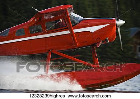 Stock Photograph - Side View Of A Cessna 206 Stationair Floatplane Landing, Alaska, USA. Fotosearch