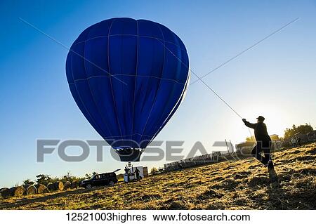 Silhouette of a person reigning in a hot air balloon, 2011 Canadian Hot Air Balloon Championships; Camrose, Alberta, Canada View Large Photo Image Stock Photograph - Silhouette of a person reigning in a hot air balloon, 2011 Canadian Hot Air Balloon Championships; Camrose, Alberta, Canada. Fotosearch