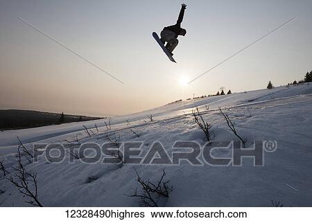 Silhouette of a snowboarder in mid-jump, South-central Alaska, Homer, Alaska, United States of America View Large Photo Image Stock Photograph - Silhouette of a snowboarder in mid-jump, South-central Alaska, Homer, Alaska, United States of America. Fotosearch