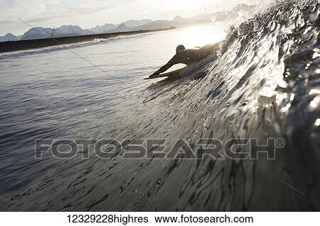 Silhouette of a surfer picking up a wave, Southeast Alaska; Yakutat, Alaska, United States of America View Large Photo Image Stock Photograph - Silhouette of a surfer picking up a wave, Southeast Alaska; Yakutat, Alaska, United States of America. Fotosearch