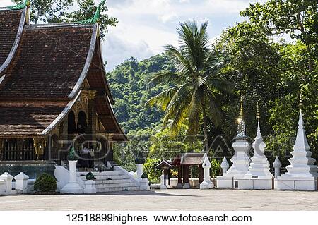 Sim (congregation hall) and stupas of Wat Xieng Thong; Luang Prabang, Laos View Large Photo Image Stock Photograph - Sim (congregation hall) and stupas of Wat Xieng Thong; Luang Prabang, Laos. Fotosearch