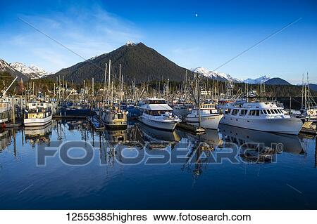Stock Photograph - Sitka Harbour with boats and their reflection and Mt. Verstovia; Sitka, Alaska, United States of America. Fotosearch
