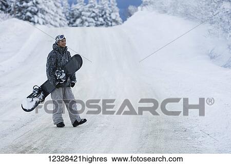 Snowboarder crossing a snow-covered road, Homer, Southcentral Alaska, USA View Large Photo Image Stock Photograph - Snowboarder crossing a snow-covered road, Homer, Southcentral Alaska, USA. Fotosearch
