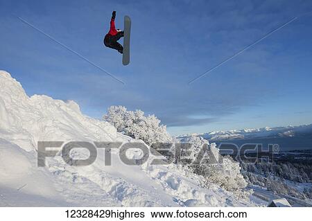 Snowboarder in the middle of a jump on a Homer hillside, Southcentral Alaska, USA View Large Photo Image Stock Photograph - Snowboarder in the middle of a jump on a Homer hillside, Southcentral Alaska, USA. Fotosearch