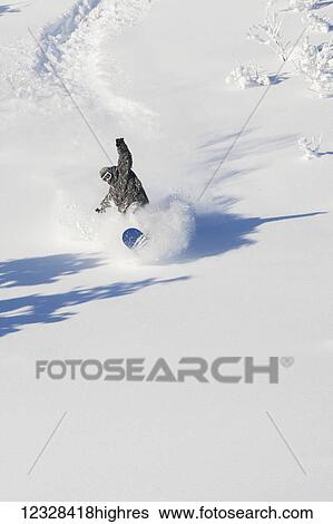 Stock Photograph - Snowboarder Making His Way Down A Mountainside, Homer, Southcentral Alaska, USA. Fotosearch
