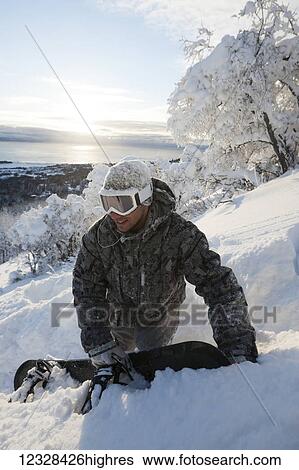 Stock Photograph - Snowboarder on a hillside, Homer, Southcentral Alaska, USA. Fotosearch