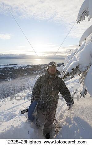 Snowboarder on a hillside overlooking Kachemak Bay at sunset, Homer, Southcentral Alaska, USA View Large Photo Image Stock Photograph - Snowboarder on a hillside overlooking Kachemak Bay at sunset, Homer, Southcentral Alaska, USA. Fotosearch