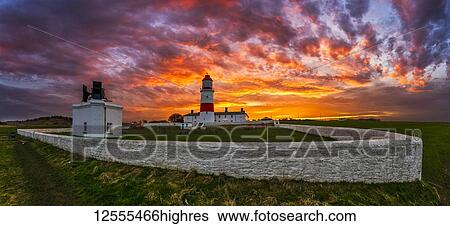 Stock Photograph - Souter Lighthouse at sunset with glowing, colourful sunset sky; South Shields, Tyne and Wear, England. Fotosearch