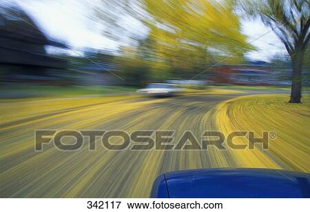 Stock Photo - Speeding down a road in autumn. Fotosearch