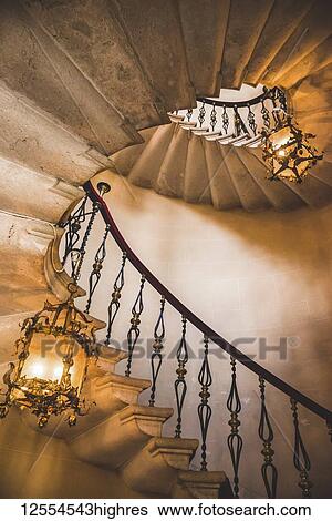 Stock Photograph - Spiral staircase and chandeliers, Duino Castle; Trieste, Friuli Venezia Giulia, Italy. Fotosearch
