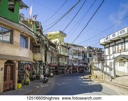 Stock Photograph - Street scene in Darjeeling with colourful buildings; Darjeeling, West Bengal, India. Fotosearch