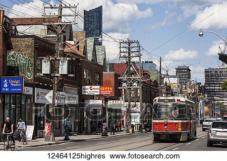 Streetcar, shops and pedestrians along a street; Toronto, Ontario, Canada View Large Photo Image Stock Photograph - Streetcar, shops and pedestrians along a street; Toronto, Ontario, Canada. Fotosearch