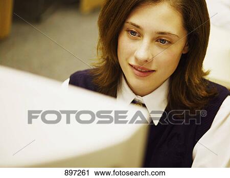 Stock Image - Student in class. Fotosearch