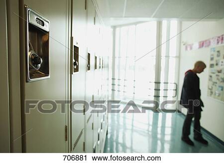 Stock Image - Student lounges in hallway. Fotosearch